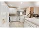 Bright kitchen featuring white appliances and a breakfast bar seating area at 5504 Crabtree Park Ct, Raleigh, NC 27612