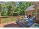 Inviting back deck with outdoor seating area and wooded views provides peaceful setting for entertaining and relaxing at 5524 Jomali Dr, Durham, NC 27705