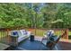 Serene outdoor deck with comfortable seating amidst lush greenery and a peaceful view at 5524 Jomali Dr, Durham, NC 27705