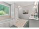 Bright bathroom with tub and double sink vanity with ample counter space at 5524 Jomali Dr, Durham, NC 27705