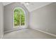 Cozy bedroom featuring a large window with serene outdoor views and neutral carpet at 5524 Jomali Dr, Durham, NC 27705