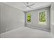 Bright bedroom with large windows offering natural light and neutral carpet flooring at 5524 Jomali Dr, Durham, NC 27705