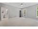 Bright bedroom with neutral carpet and paint, adjacent bath, and access to the outdoor deck at 5524 Jomali Dr, Durham, NC 27705