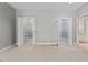 Open shelved walk-in closets with neutral carpet, adjacent to a bathroom at 5524 Jomali Dr, Durham, NC 27705