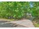 Long driveway leading to a house surrounded by lots of trees at 5524 Jomali Dr, Durham, NC 27705