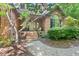 Charming brick home featuring a welcoming front porch, mature landscaping, and a classic design at 5524 Jomali Dr, Durham, NC 27705