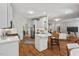 Open concept kitchen featuring white cabinets, stainless steel appliances, and a breakfast bar at 5524 Jomali Dr, Durham, NC 27705