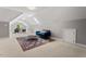 Bright living room with skylights, a blue couch, and neutral carpet at 5524 Jomali Dr, Durham, NC 27705