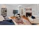 Cozy living room with fireplace, hardwood floors, and a well-lit ambiance at 5524 Jomali Dr, Durham, NC 27705