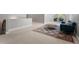 Spacious living room featuring a blue couch, patterned rug, and carpet flooring at 5524 Jomali Dr, Durham, NC 27705