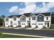 Multiple townhomes with one-car garages, siding, and well-manicured lawns, showing off a picturesque curb appeal at 58 Twin Birch Dr, Angier, NC 27501