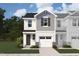 A beautifully rendered townhome with a one-car garage, gray siding, and a well-manicured front lawn at 58 Twin Birch Dr, Angier, NC 27501