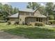Expansive backyard featuring lush lawn, brick house exterior, and mature trees at 5901 Charleycote Dr, Raleigh, NC 27614