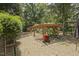 Landscaped backyard featuring a wooden pergola covered in trees at 5901 Charleycote Dr, Raleigh, NC 27614