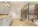 The bathroom offers double vanities, soaking tub, separate glass enclosed shower, and tile flooring at 5901 Charleycote Dr, Raleigh, NC 27614
