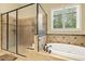 This bathroom features a soaking tub with tile surround and a separate glass-enclosed shower at 5901 Charleycote Dr, Raleigh, NC 27614