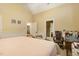 Well-lit bedroom with decorative paneling, desk area, and easy access to other rooms in the house at 5901 Charleycote Dr, Raleigh, NC 27614