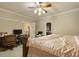 Comfortable bedroom with a four-poster bed, desk, and a convenient access to other rooms at 5901 Charleycote Dr, Raleigh, NC 27614