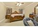 Elegant bedroom with ornate wood bed frame, matching nightstand, and a comfortable sitting area at 5901 Charleycote Dr, Raleigh, NC 27614