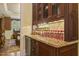 Butler's pantry with custom cabinets, wine refrigerator, and granite countertops at 5901 Charleycote Dr, Raleigh, NC 27614