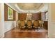 Formal dining room with hardwood floors, decorative wallpaper, and an elegant chandelier at 5901 Charleycote Dr, Raleigh, NC 27614