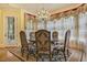 Dining room with decorative chandelier, detailed curtains, and a formal dining table with seating for six at 5901 Charleycote Dr, Raleigh, NC 27614