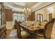 Charming dining room with hardwood floors, chandelier, and a beautifully set table for a sophisticated dining experience at 5901 Charleycote Dr, Raleigh, NC 27614