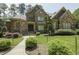 Beautiful stone and brick home with meticulously manicured landscaping and a charming front entrance at 5901 Charleycote Dr, Raleigh, NC 27614