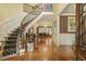 Grand foyer with a curved staircase, hardwood floors, and elegant decor, showcasing the home's luxurious interior at 5901 Charleycote Dr, Raleigh, NC 27614