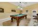 Spacious game room with ornate pool table, unique lighting and decor at 5901 Charleycote Dr, Raleigh, NC 27614