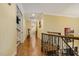 An upstairs hallway features hardwood floors, recessed lighting, and wrought iron railing at 5901 Charleycote Dr, Raleigh, NC 27614