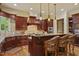 A traditional kitchen with a breakfast bar island, custom cabinets, granite countertops, and stainless steel appliances at 5901 Charleycote Dr, Raleigh, NC 27614