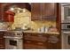 Close up of kitchen featuring stainless steel Wolf range and custom backsplash at 5901 Charleycote Dr, Raleigh, NC 27614