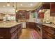 View of kitchen with custom wood cabinets, granite countertops, tile backsplash, and stainless steel appliances at 5901 Charleycote Dr, Raleigh, NC 27614