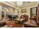 Spacious living room featuring a Yamaha piano, ornate furniture, and a chandelier at 5901 Charleycote Dr, Raleigh, NC 27614