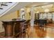 Spacious living area featuring hardwood floors, a custom bar, and a grand piano perfect for entertaining at 5901 Charleycote Dr, Raleigh, NC 27614