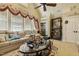 Inviting living room featuring a large sectional couch, decorative window treatments, and elegant display shelves at 5901 Charleycote Dr, Raleigh, NC 27614