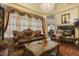 Living room showcasing a fireplace, ornate furniture, and chandelier-style lighting at 5901 Charleycote Dr, Raleigh, NC 27614