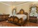 Luxurious main bedroom features decorative bed frame, matching side tables, and window treatments at 5901 Charleycote Dr, Raleigh, NC 27614
