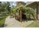 Stone patio featuring a vine-covered pergola with a grill and prep station providing a lovely outdoor space at 5901 Charleycote Dr, Raleigh, NC 27614