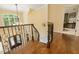 A curved staircase boasts hardwood floors, a chandelier, and wrought iron railings at 5901 Charleycote Dr, Raleigh, NC 27614