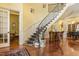 Elegant staircase with a decorative wrought iron railing and plush patterned carpet leading to the upper level at 5901 Charleycote Dr, Raleigh, NC 27614