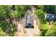 Aerial view of a single Gathering home with driveway, large backyard, and surrounded by lush greenery at 604 Natchez Trace, Fuquay Varina, NC 27526