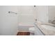 Bathroom featuring wood-look flooring, granite countertops, and a shower-tub combo with white tiled walls at 604 Natchez Trace, Fuquay Varina, NC 27526