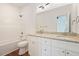 Bright bathroom with white cabinets, granite countertops, double sinks, and a shower tub combo at 604 Natchez Trace, Fuquay Varina, NC 27526