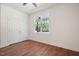 Spacious bedroom with wood-look floors, closet, and large window that allows a lot of natural light at 604 Natchez Trace, Fuquay Varina, NC 27526