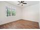 Bedroom with a ceiling fan and large window allowing ample natural light to illuminate the wood-look flooring at 604 Natchez Trace, Fuquay Varina, NC 27526