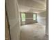 Unfinished bedroom with drywall, two bright windows, and bare floors awaiting personalization and decoration at 604 Natchez Trace, Fuquay Varina, NC 27526