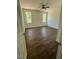 Bright bedroom featuring two windows, a ceiling fan, and wood-look flooring at 604 Natchez Trace, Fuquay Varina, NC 27526