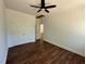 Bedroom featuring wood-look floors, closet with paneled doors, and ceiling fan at 604 Natchez Trace, Fuquay Varina, NC 27526